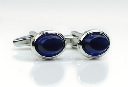 Oval shaped cufflinks with blue glass inlay