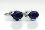 Oval shaped cufflinks with blue glass inlay